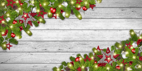 Fototapeta na wymiar xmas christmas dark wood background with decorated fir branches with many lights and copy space / Festlicher Weihnachten Hintergrund auf holz mit geschmückten tannenzweigen