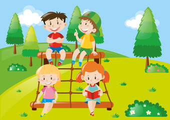 Four kids playing at climbing station