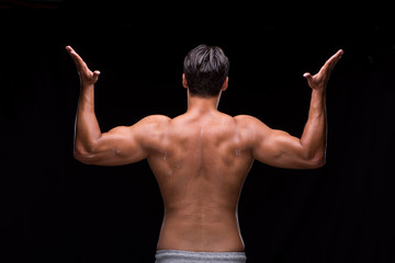 Ripped muscular man on black background