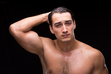 Fototapeta premium Ripped muscular handsome man on black background