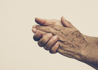 hands of a female elderly in old vintage tone