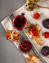 Jam of Figs on a Gray Concrete Background of Autumn. top view. selective focus.