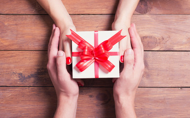 Woman with man holding a christmas gift