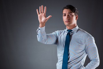 Handsome businessman pressing virtual buttons