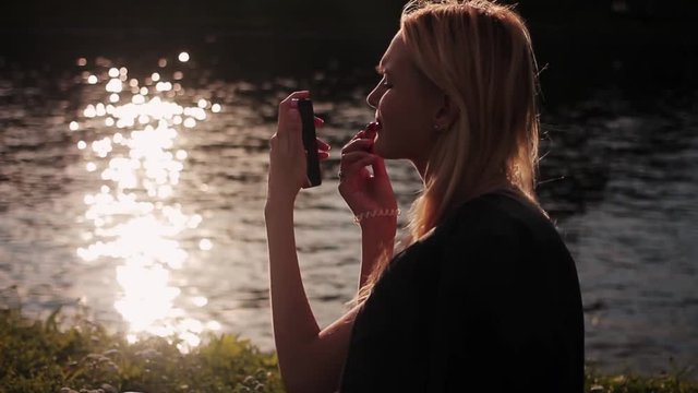 Beautiful young girl taking selfie at sunset. HD