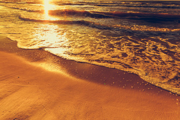 Beatiful sunset with clouds over sea and beach