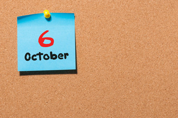 October 6th. Day 6 of month, color sticker calendar on notice board. Autumn time. Empty space for text