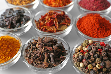 Various spices in glass bowls, close up
