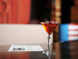 Tasty cocktail on wooden table in bar