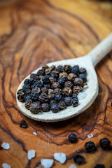 Chili with black pepper and salt on rustic wooden table. Overhead view food photography.