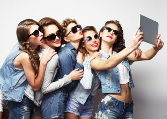 five hipster girls friends taking selfie with digital tablet