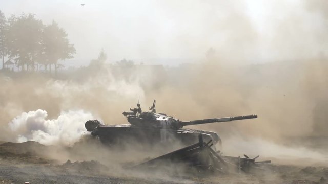 shooting russian tank, Tank rides with dust and smoke, military action, invading tank