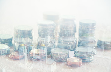Double exposure city and row of coins, finance and banking concept