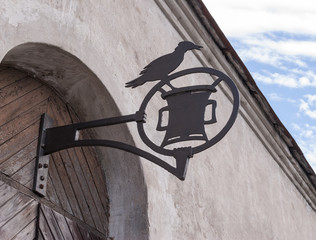 vintage wrought iron sign on wooden door
