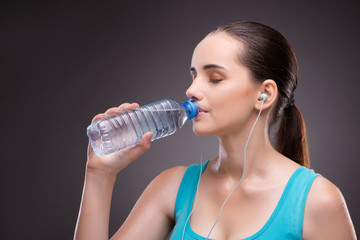 Woman doing sports with bottle of fresh water