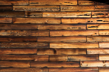 Close up of rows of old weathered short wood boards on old house