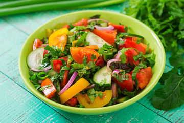 Fresh salad of tomatoes, cucumbers, peppers, arugula and red onion
