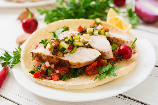 Mexican tacos with chicken and salsa.