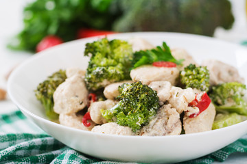 Delicate saute chicken with broccoli and chili peppers in a creamy garlic sauce