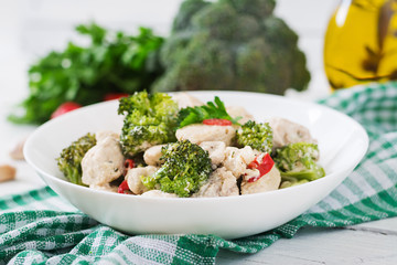 Delicate saute chicken with broccoli and chili peppers in a creamy garlic sauce