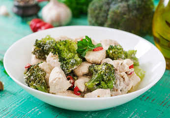 Delicate saute chicken with broccoli and chili peppers in a creamy garlic sauce