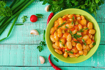 Steamed white beans with vegetables in tomato sauce. Top view