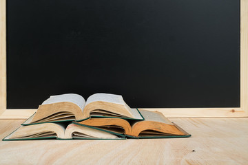 books  on  desk with bord blacground