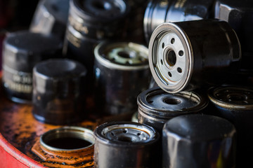 Picture of old car oil filters represented in automobile service center. Old fuel filters of diesel...