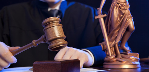 Male judge in a courtroom striking the gavel