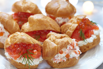 Profiteroles with fish and red caviar