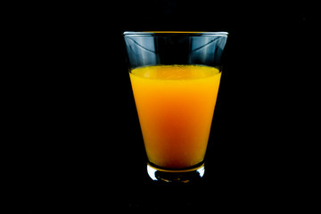 Orange juice. Black background