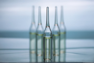transparent vials of medicine