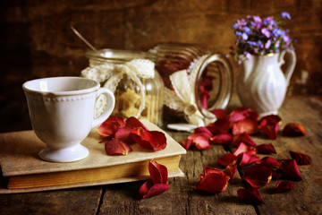 retro effect on photo vintage tea with rose dry petal