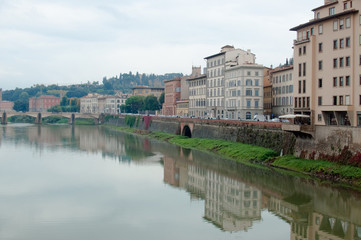 Florence, Ponte alla Carraia medieval Bridge landmark on Arno river, sunset landscape with reflection. Tuscany, Italy. Popular touristic view, travel destination.