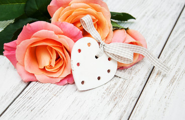 Pink roses on a wooden background