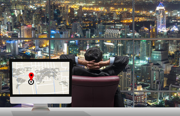 Back side of sitting businessman who is looking at cityscape out