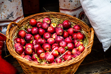 Red ripe apples lying in a wicker basket.