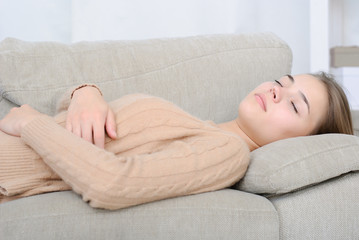 smiling young woman lying on couch