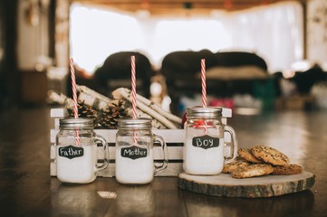 three containers of milk and cookies, winter scenery, family