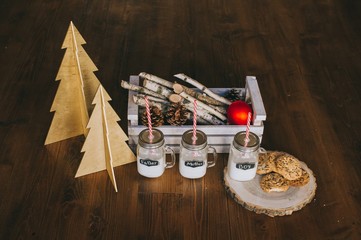 three containers of milk and cookies, winter scenery, family
