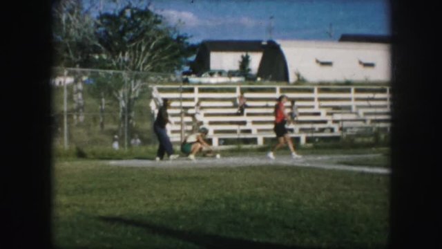 1958: Baseball Player Swings Bat Twice And Is Tagged Out During Women's Game. AMES, IOWA