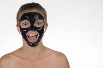 Happy beautiful girl with acne on a white background in a cosmet