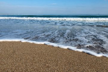 foamy wave on the sand beach