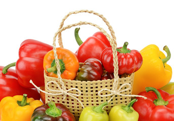 Set bell peppers in a basket isolated on a white background