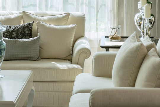 white and gray decorative pillows on a casual sofa in the living roon