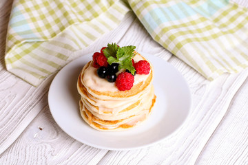 Summer cottage cheese pancakes on white plates on a table