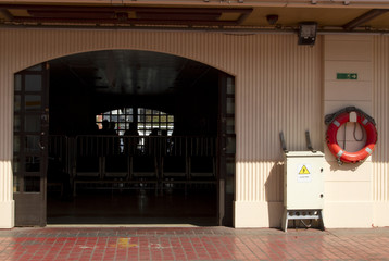 Wide old gate and old wall with exit label