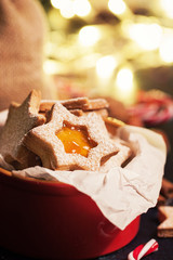 Homemade christmas cookies with jam in a bowl, christmas background and decoration, closeup.