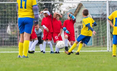 Foto op Plexiglas Boys playing football soccer game on sports field © Dusan Kostic