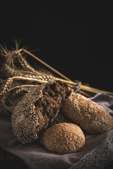 Different fresh bread on old wooden table
